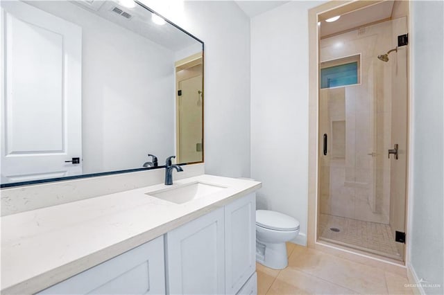 bathroom featuring tile patterned floors, vanity, and a shower with shower door