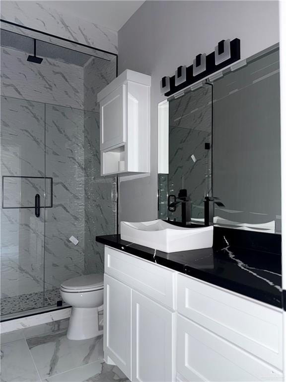 532 Demi St, Edinburg, TX 78542 - bathroom featuring a marble finish shower, marble look tiles, vanity, and toilet