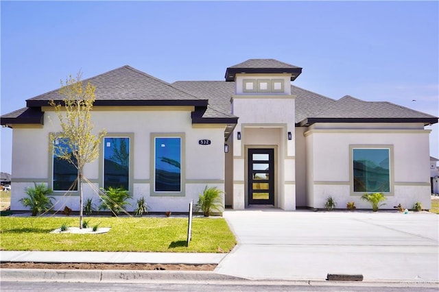 532 Demi St, Edinburg, TX 78542 - prairie-style house with roof with shingles, a front yard, and stucco siding