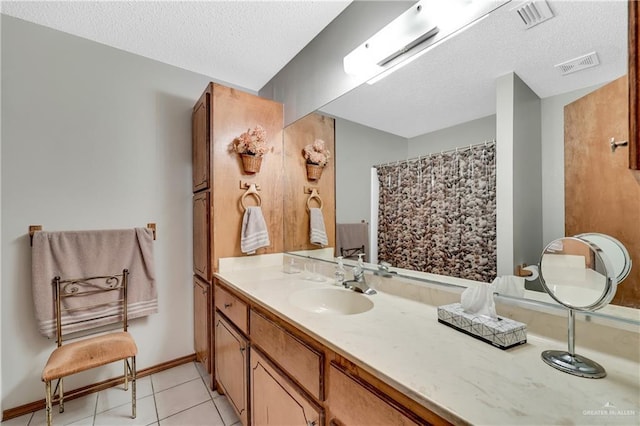 bathroom featuring vanity, a shower with curtain, tile patterned floors, and a textured ceiling