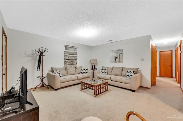 living room with a textured ceiling and carpet floors