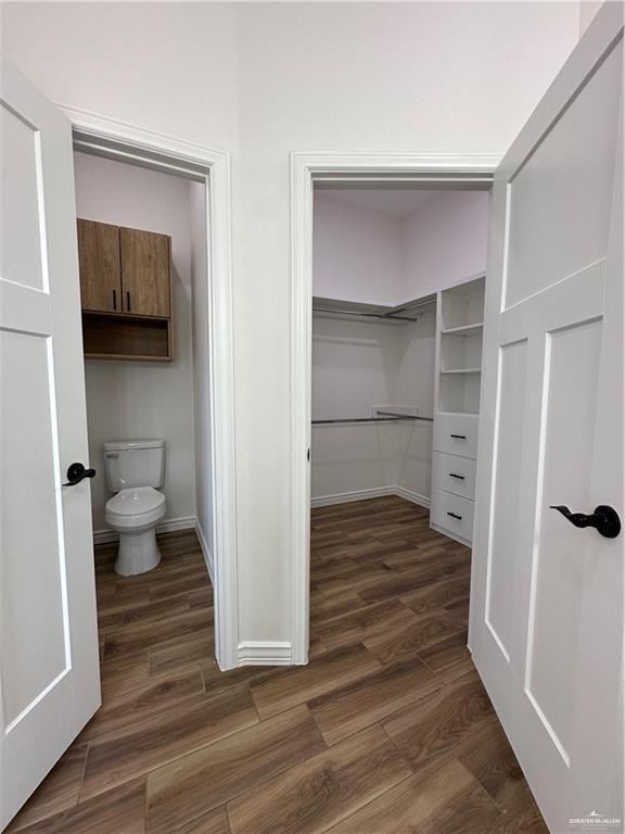 2413 N Woody St, Edinburg, TX 78541 - bathroom with wood finished floors, toilet, and baseboards