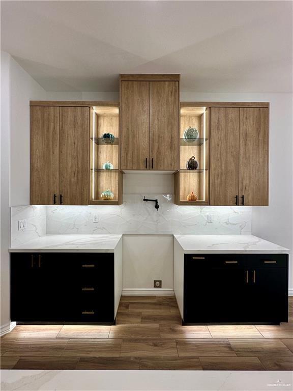 2413 N Woody St, Edinburg, TX 78541 - kitchen featuring open shelves, light countertops, wood finished floors, and decorative backsplash