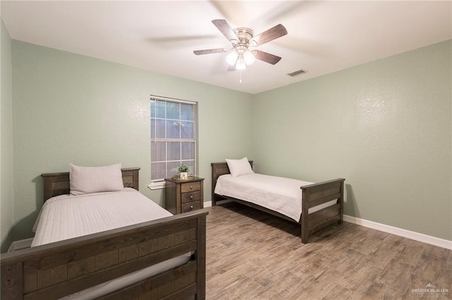 bedroom featuring light hardwood / wood-style floors and ceiling fan