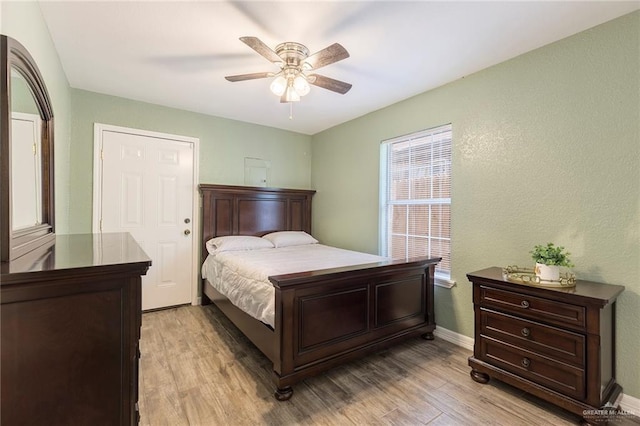 bedroom with ceiling fan and light wood-type flooring