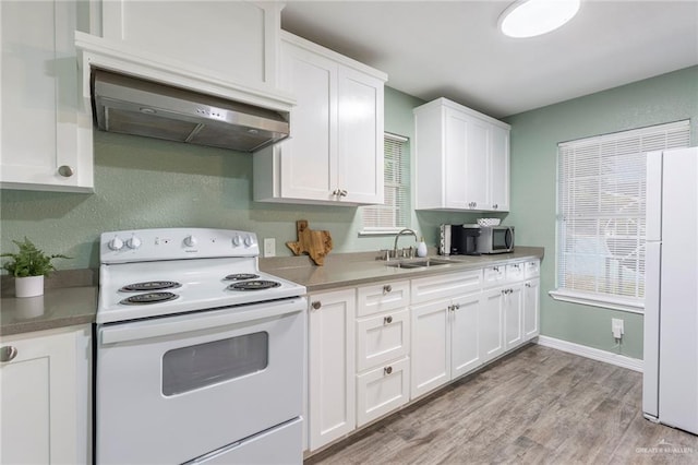 kitchen with white appliances, sink, light hardwood / wood-style flooring, white cabinetry, and range hood