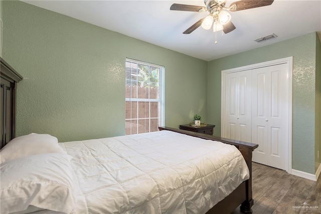 bedroom featuring wood-type flooring, a closet, and ceiling fan