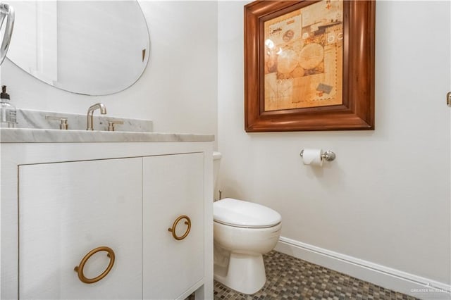 bathroom with tile patterned floors, vanity, and toilet