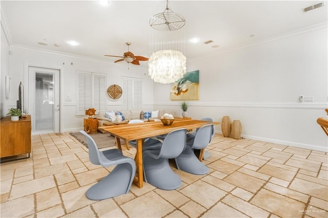 dining room with ceiling fan with notable chandelier and ornamental molding