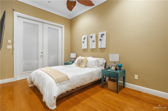 bedroom featuring ceiling fan, wood-type flooring, and ornamental molding