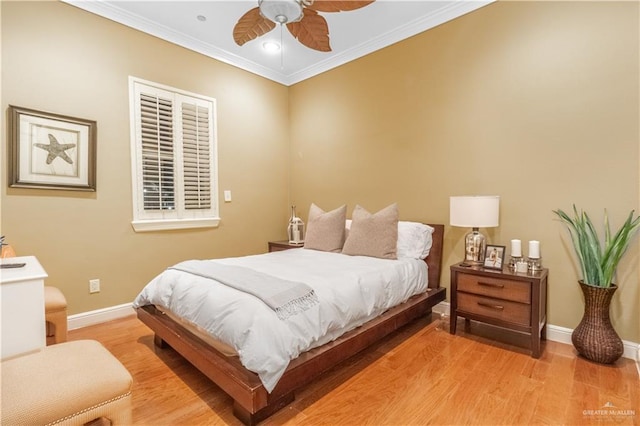 bedroom featuring light hardwood / wood-style floors, ceiling fan, and ornamental molding