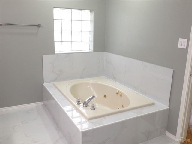 bathroom featuring tiled tub