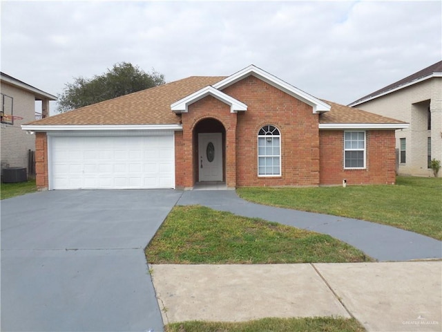 single story home featuring cooling unit, a front yard, and a garage