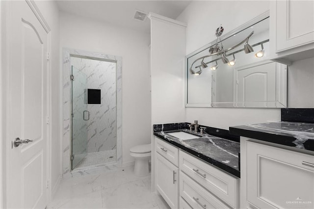 bathroom with vanity, toilet, and walk in shower