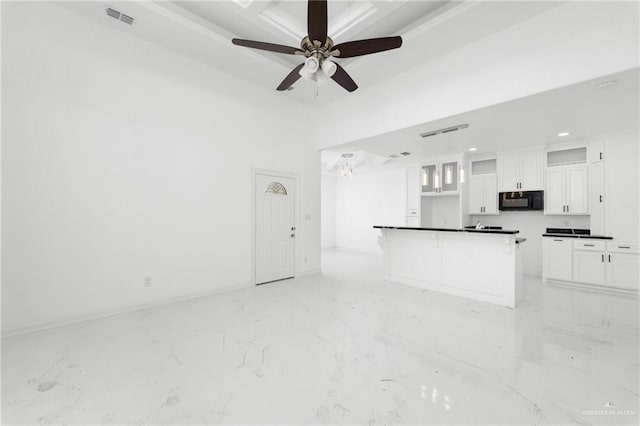 unfurnished living room featuring ceiling fan