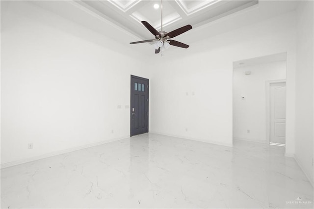 spare room featuring beamed ceiling, ceiling fan, a high ceiling, and coffered ceiling