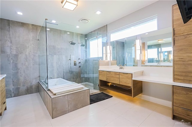 bathroom featuring tile patterned flooring, vanity, separate shower and tub, and a wealth of natural light