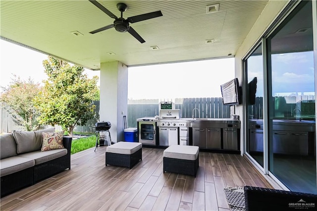 view of patio with sink, an outdoor kitchen, an outdoor hangout area, and grilling area