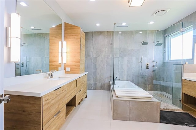 bathroom featuring tile patterned floors, vanity, tile walls, and independent shower and bath