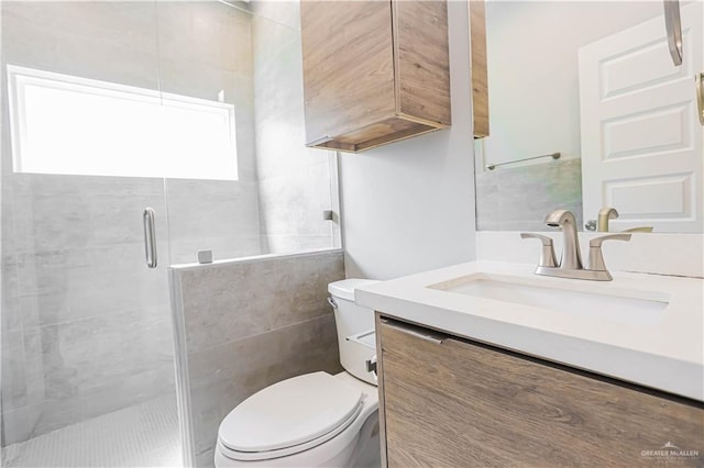 bathroom with vanity, toilet, and a shower with door