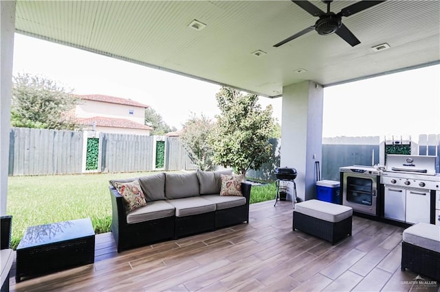 view of patio with outdoor lounge area, ceiling fan, and a grill