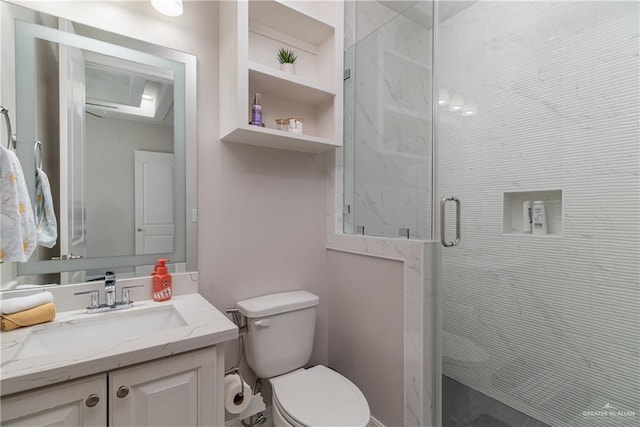 bathroom with vanity, toilet, and a shower with shower door