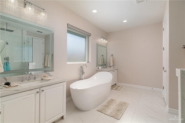 bathroom with vanity and shower with separate bathtub