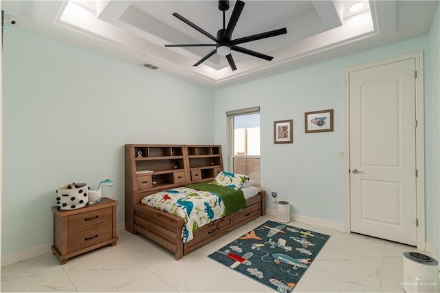 bedroom featuring ceiling fan and a tray ceiling