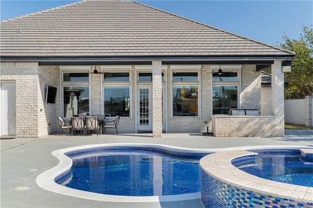 view of swimming pool featuring a patio, ceiling fan, and an in ground hot tub