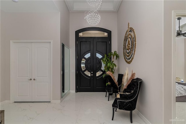 foyer entrance with a notable chandelier