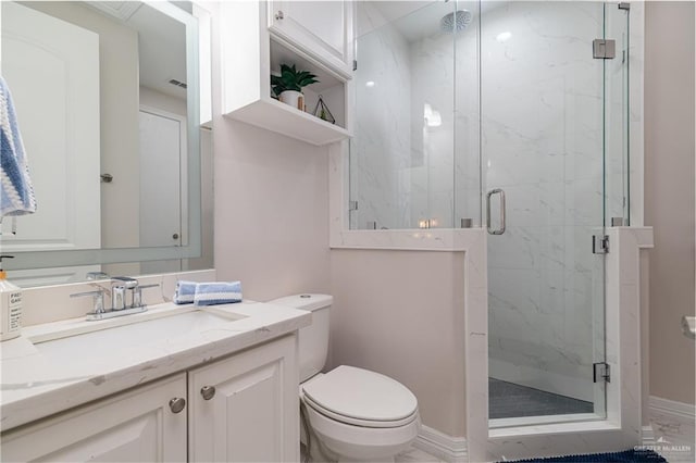 bathroom with an enclosed shower, vanity, and toilet