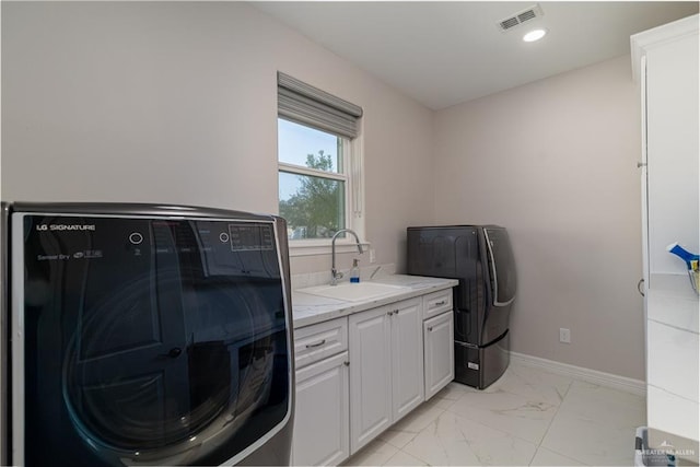 washroom with sink and cabinets