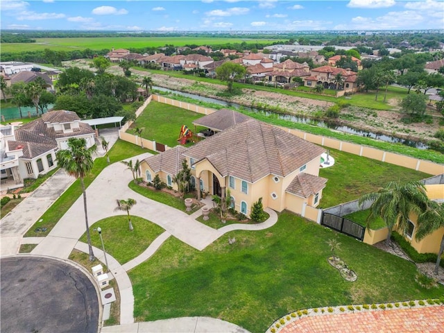drone / aerial view with a water view and a residential view
