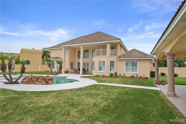 back of house with a tiled roof, fence, a patio area, a yard, and stucco siding