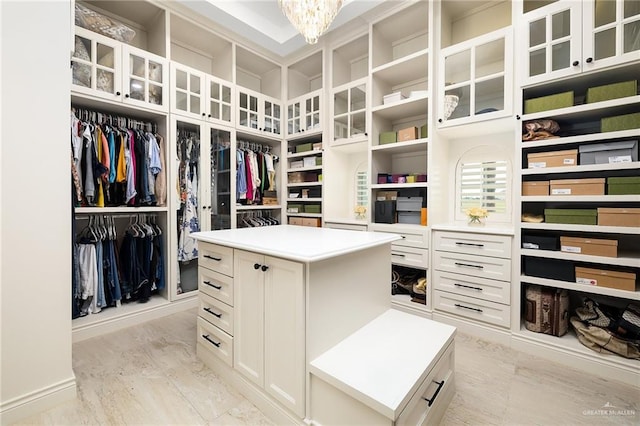 spacious closet featuring an inviting chandelier