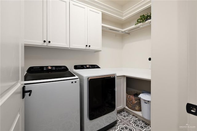 laundry room with independent washer and dryer and cabinet space