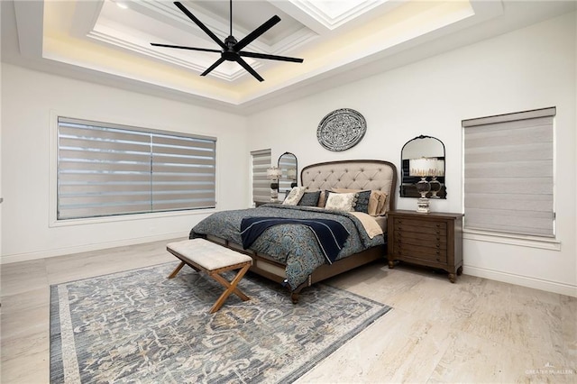 bedroom with baseboards, coffered ceiling, wood finished floors, and beamed ceiling