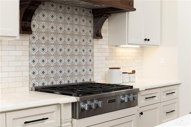 kitchen with gas cooktop, decorative backsplash, white cabinets, and light countertops