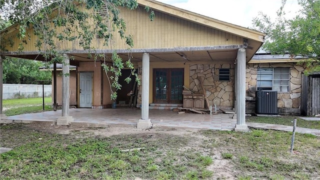 612 W Ramirez St, Rio Grande City, TX 78582 - rear view of property featuring french doors, a patio area, and stone siding