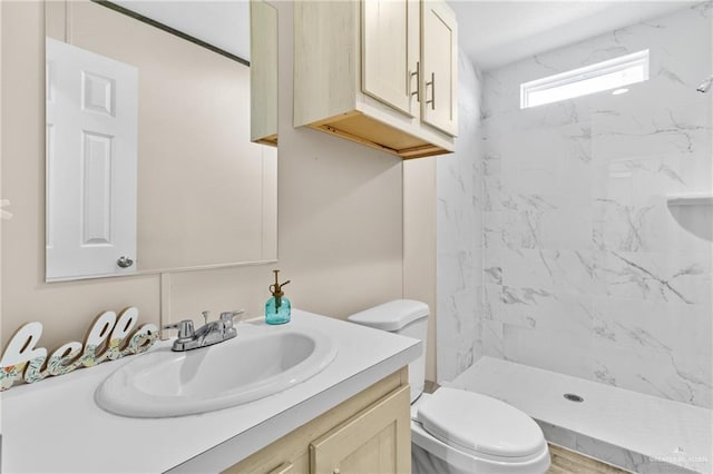 bathroom featuring vanity, toilet, and a shower