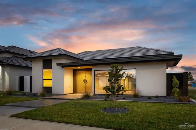 prairie-style house featuring a yard