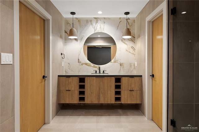 bathroom featuring tile patterned flooring, vanity, and tile walls