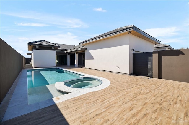 view of pool featuring an in ground hot tub and a deck