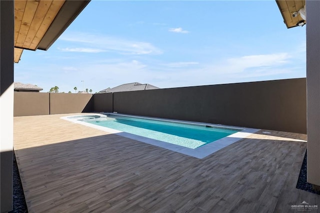 view of swimming pool with a wooden deck