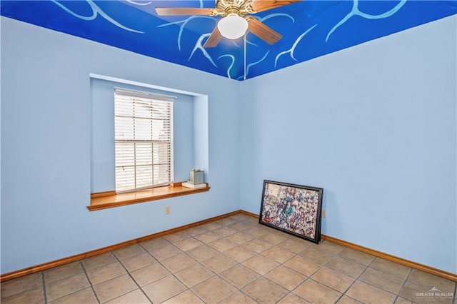 spare room featuring tile patterned floors and ceiling fan