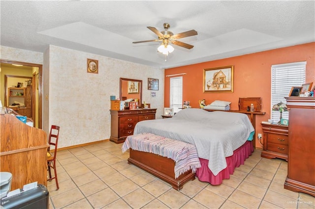 bedroom with a textured ceiling, ceiling fan, and light tile patterned flooring