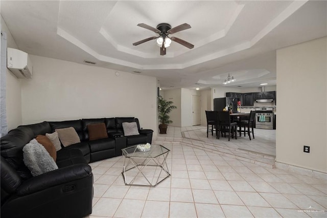 living room featuring ceiling fan, a raised ceiling, light tile patterned floors, and a wall mounted AC