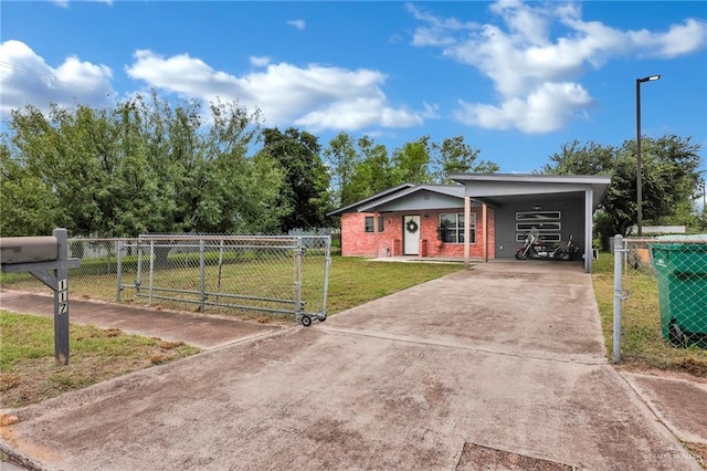117 W Hawk Ave, Pharr, TX 78577 - view of front facade featuring driveway, a gate, brick siding, and an attached carport
