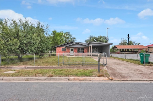 117 W Hawk Ave, Pharr, TX 78577 - view of front of home featuring a fenced front yard, concrete driveway, and an attached carport