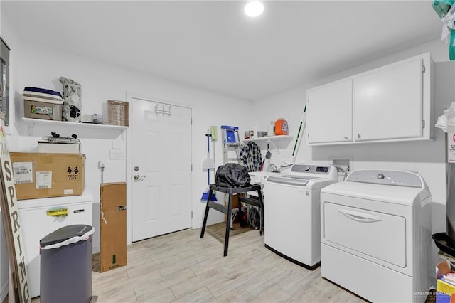 117 W Hawk Ave, Pharr, TX 78577 - laundry room featuring cabinet space, washing machine and dryer, and light wood-style floors